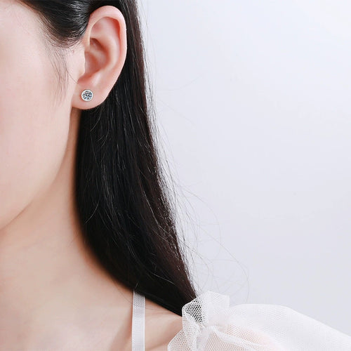 Bezel Round Moissanite Stud Earrings in Rhodium-Plated S925 Sterling Silver worn on ear by model to show scale, drop length, and everyday styling