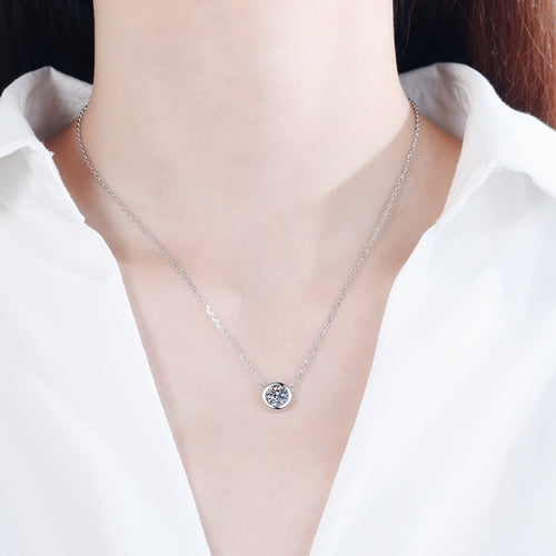Bezel Solitaire Moissanite Necklace in Rhodium-Plated S925 sterling silver worn on neckline by model showing scale and adjustable chain styling