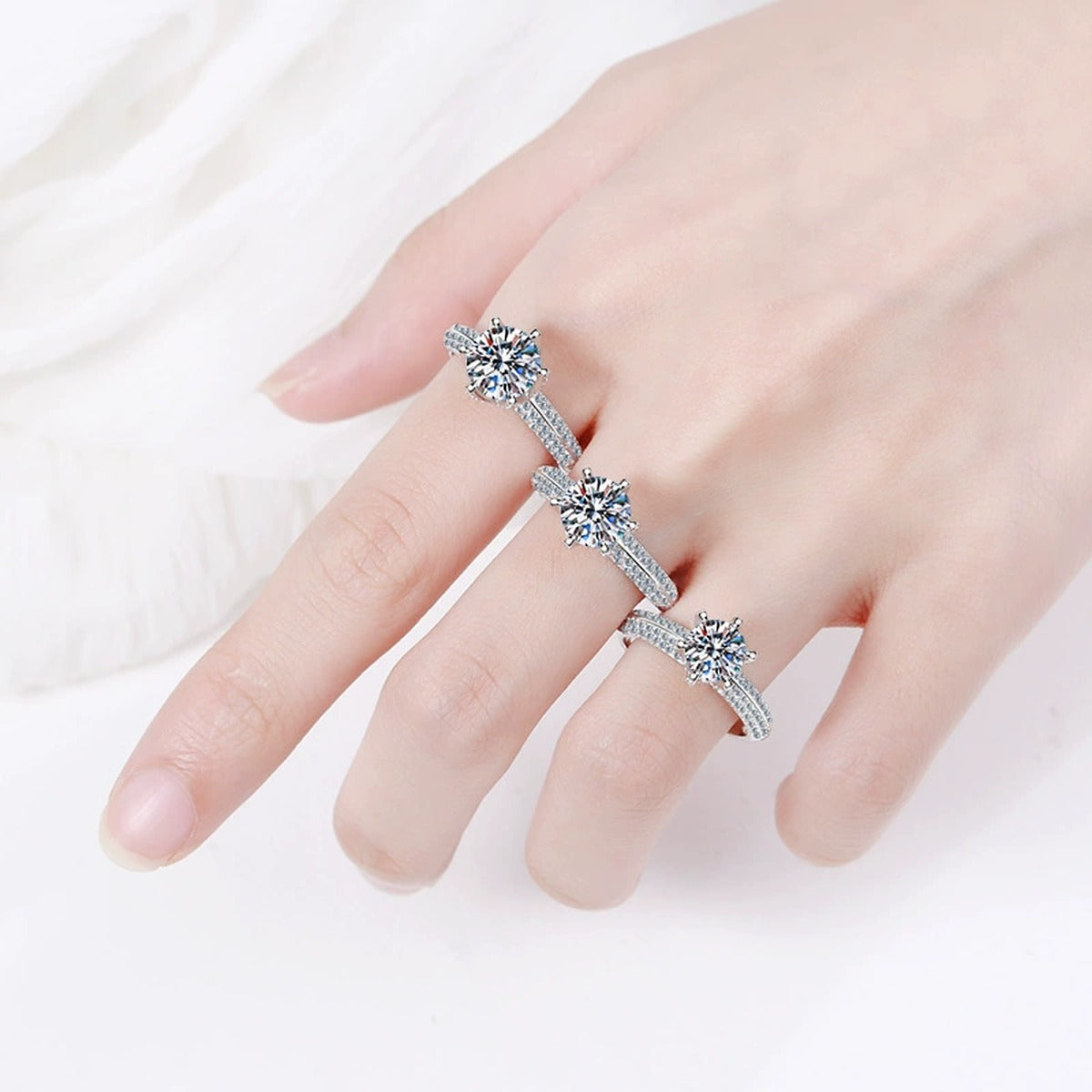 Round Moissanite Side Stone Ring with CZ worn on hand to show scale and ring profile