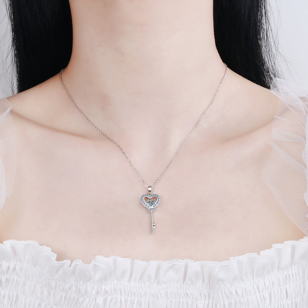 Heart Key Moissanite Pendant Necklace with CZ in Rhodium-Plated S925 sterling silver worn on neckline by model showing scale and adjustable chain styling