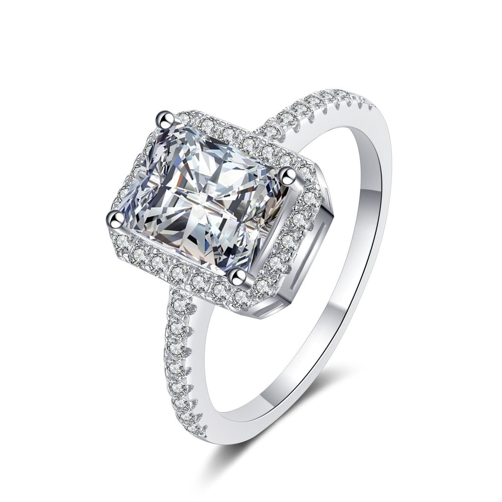 Emerald Cut Moissanite Halo Ring with CZ in rhodium-plated S925 sterling silver on clean white background