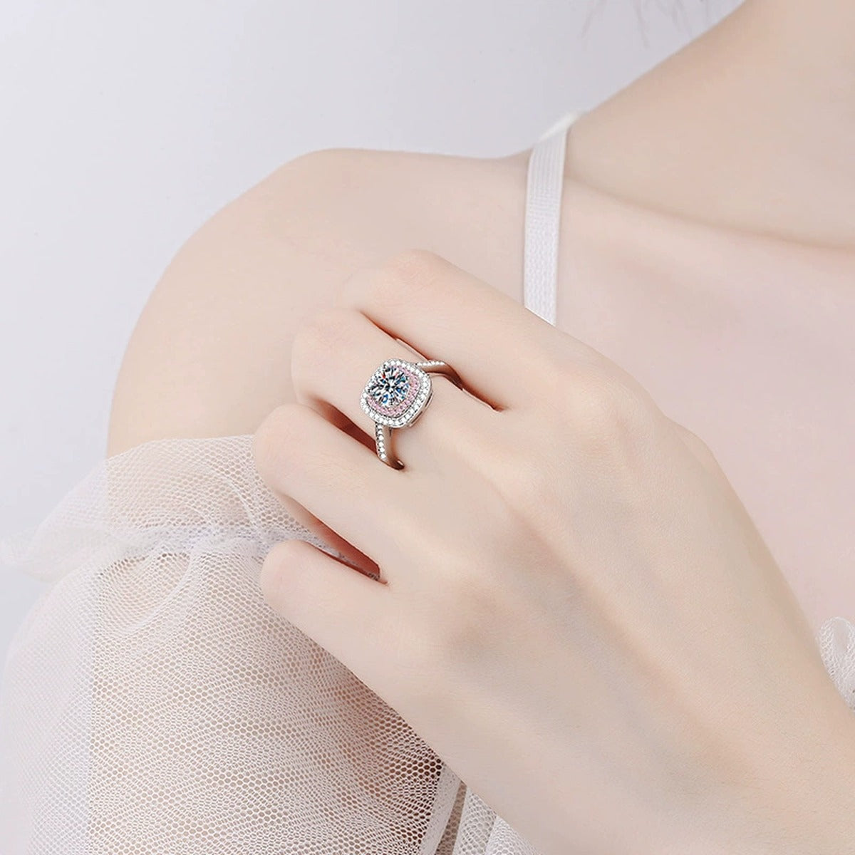 Pink Halo Moissanite Ring with CZ worn on hand to show scale and ring profile