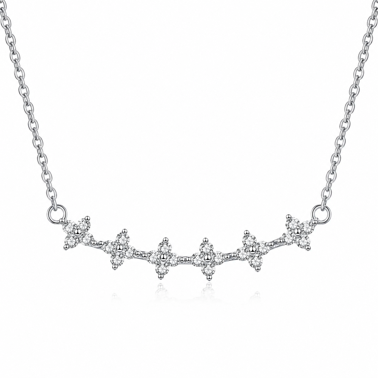 A silver-toned necklace featuring a delicate chain and a central branch-like cluster of small clear stones, shown on a plain white background.