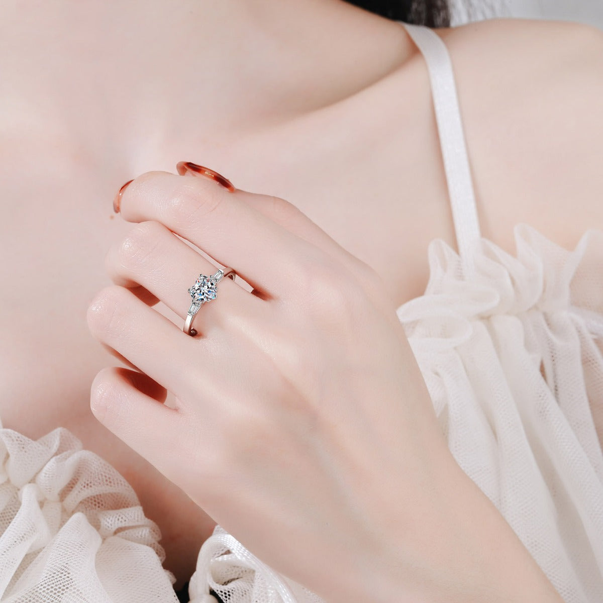 Heart Cut Moissanite Ring with CZ worn on hand to show scale, band width, and ring profile