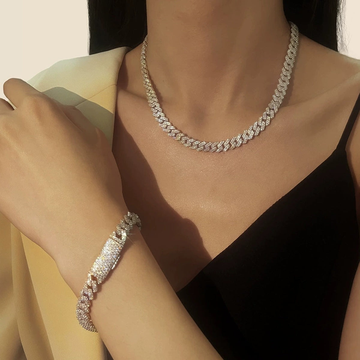 White gold-plated iced Cuban link moissanite necklace styled with matching bracelet on model