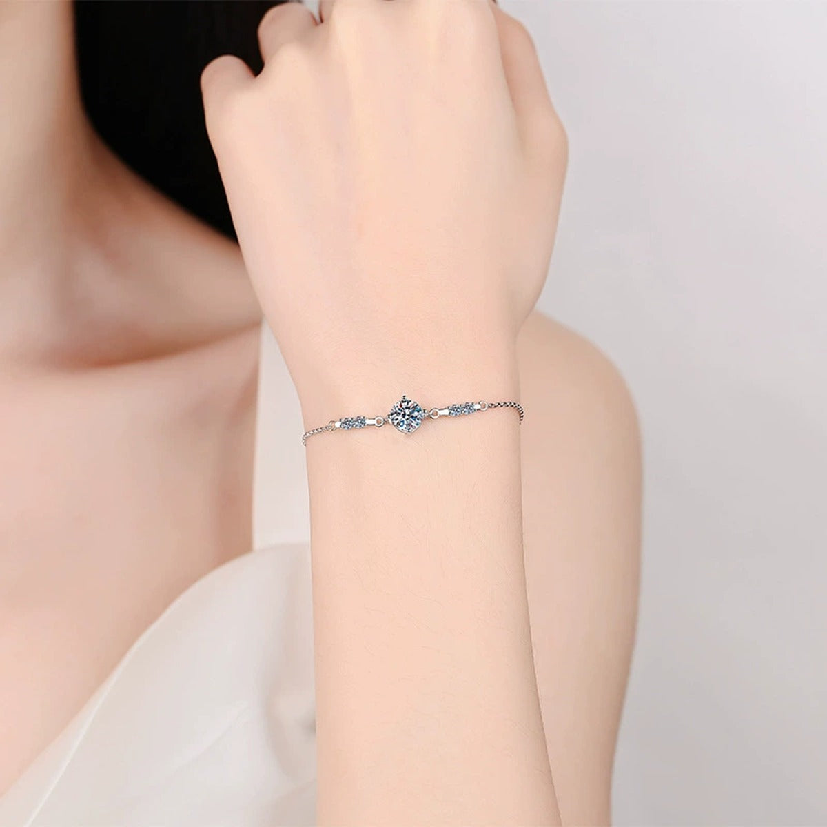 Round Moissanite Adjustable Station Bracelet with CZ worn on wrist by model showing scale and bracelet fit