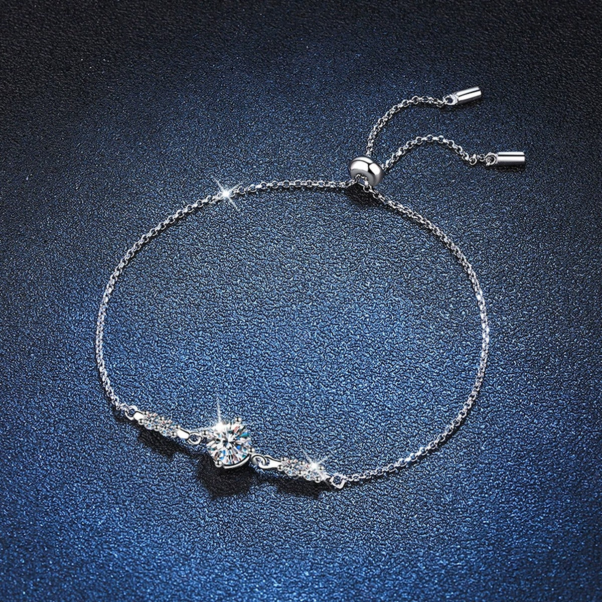 Round Moissanite Adjustable Station Bracelet with CZ styled on blue display background with visible moissanite sparkle