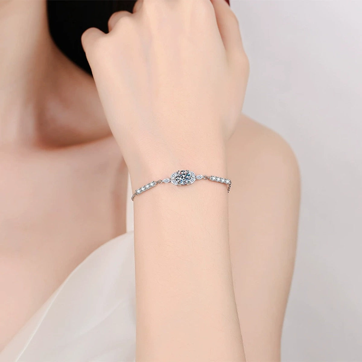 Oval Moissanite Adjustable Station Bracelet with CZ worn on wrist by model showing scale and bracelet fit