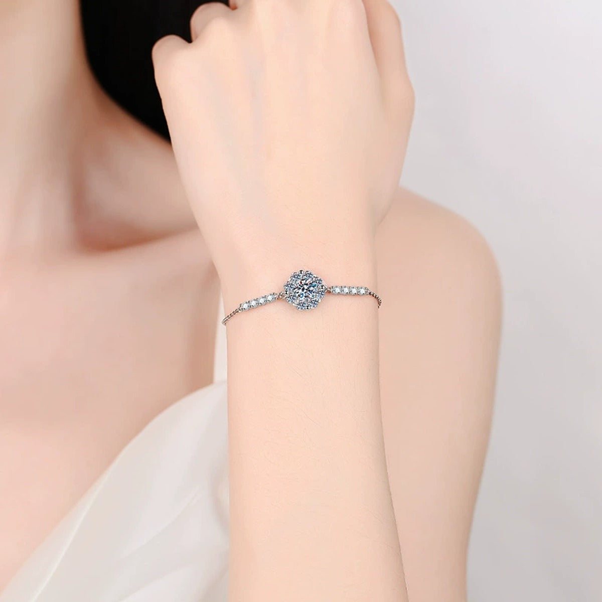 Halo Round Moissanite Adjustable Station Bracelet with CZ worn on wrist by model showing scale and bracelet fit
