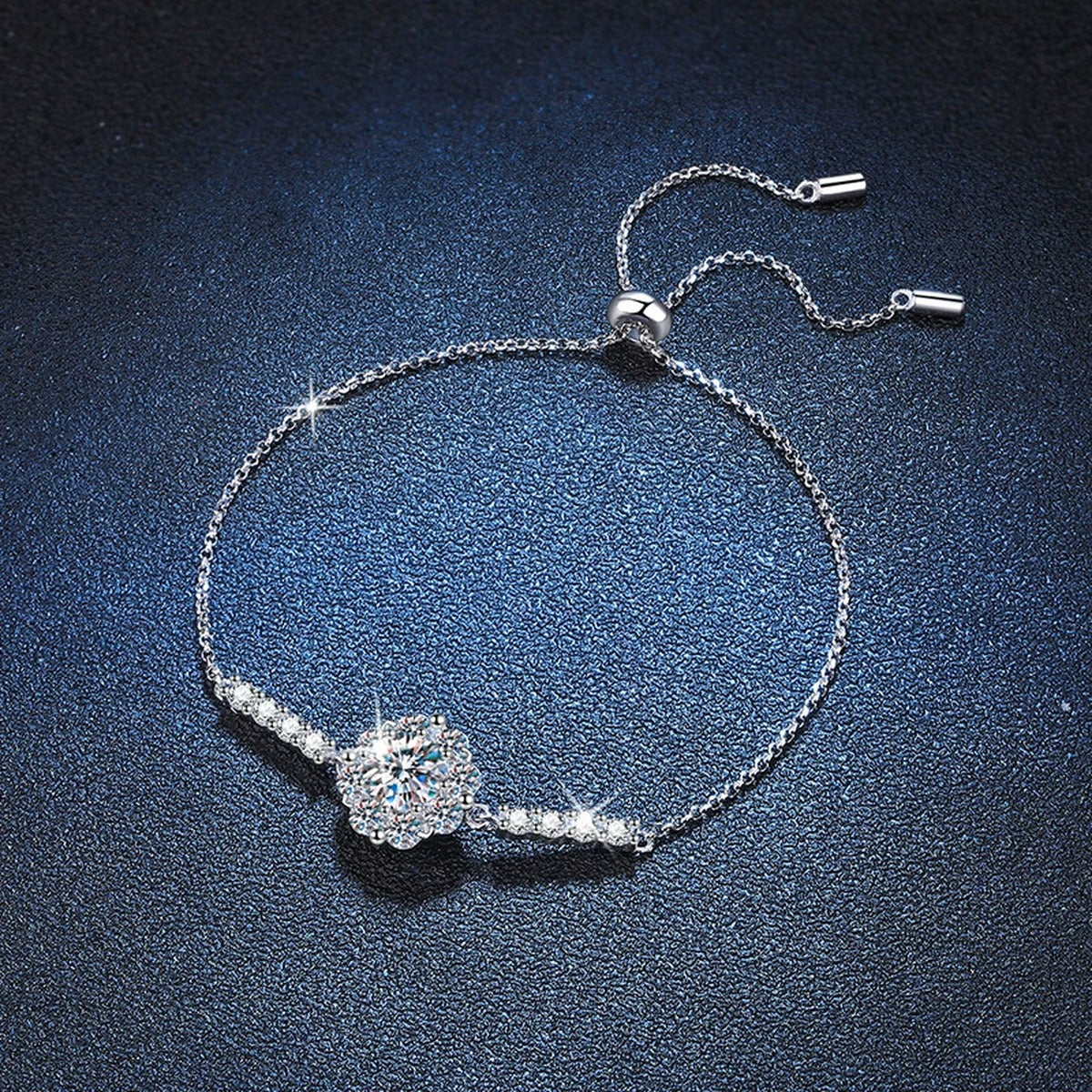 Halo Round Moissanite Adjustable Station Bracelet with CZ styled on blue display background with visible moissanite sparkle