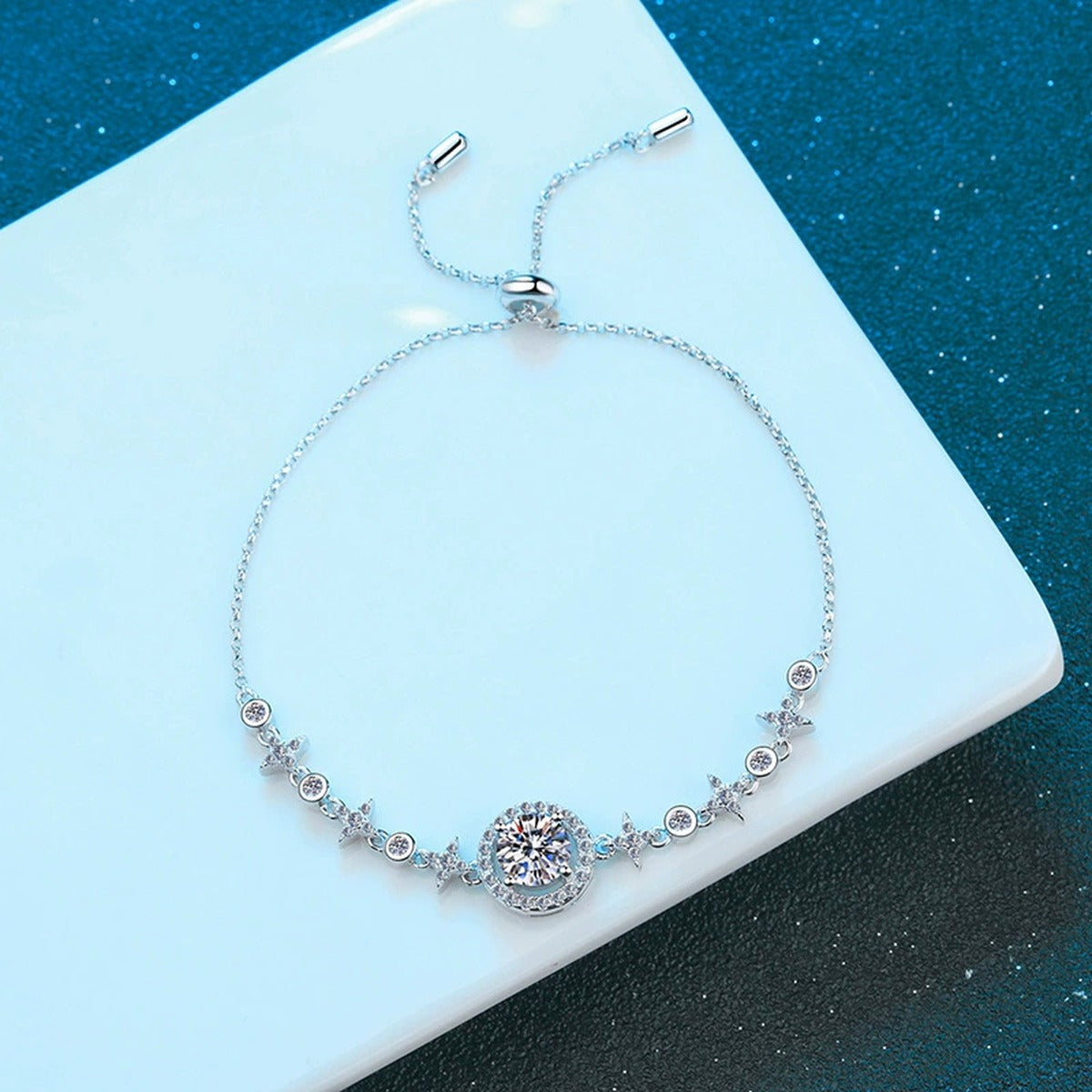 Moon and Star Moissanite Adjustable Bracelet with CZ styled on blue display background with visible moissanite sparkle