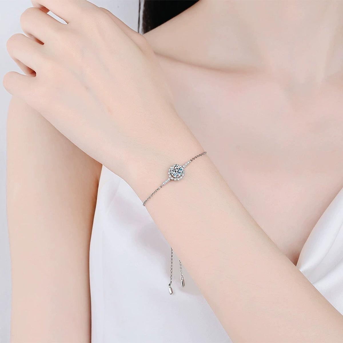 Round Halo Moissanite Adjustable Station Bracelet with CZ worn on wrist by model showing scale and bracelet fit