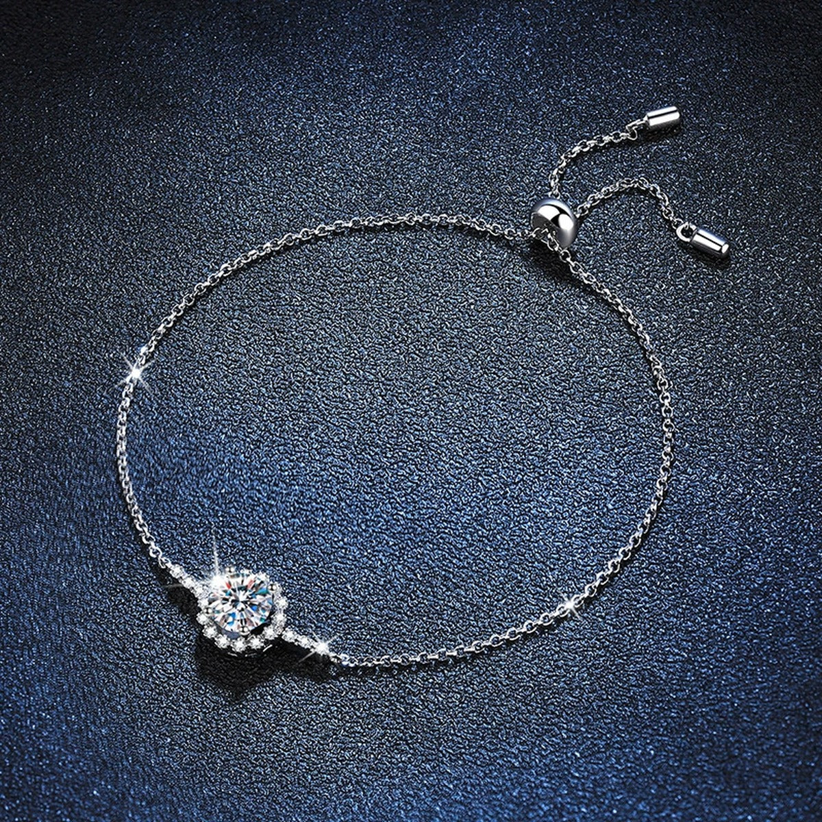 Round Halo Moissanite Adjustable Station Bracelet with CZ styled on blue display background with visible moissanite sparkle