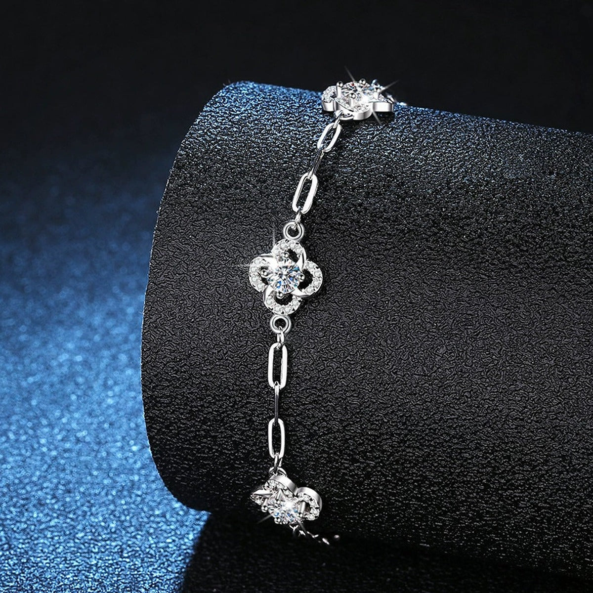 Round Moissanite Station Bracelet with CZ styled on blue display background with visible moissanite sparkle