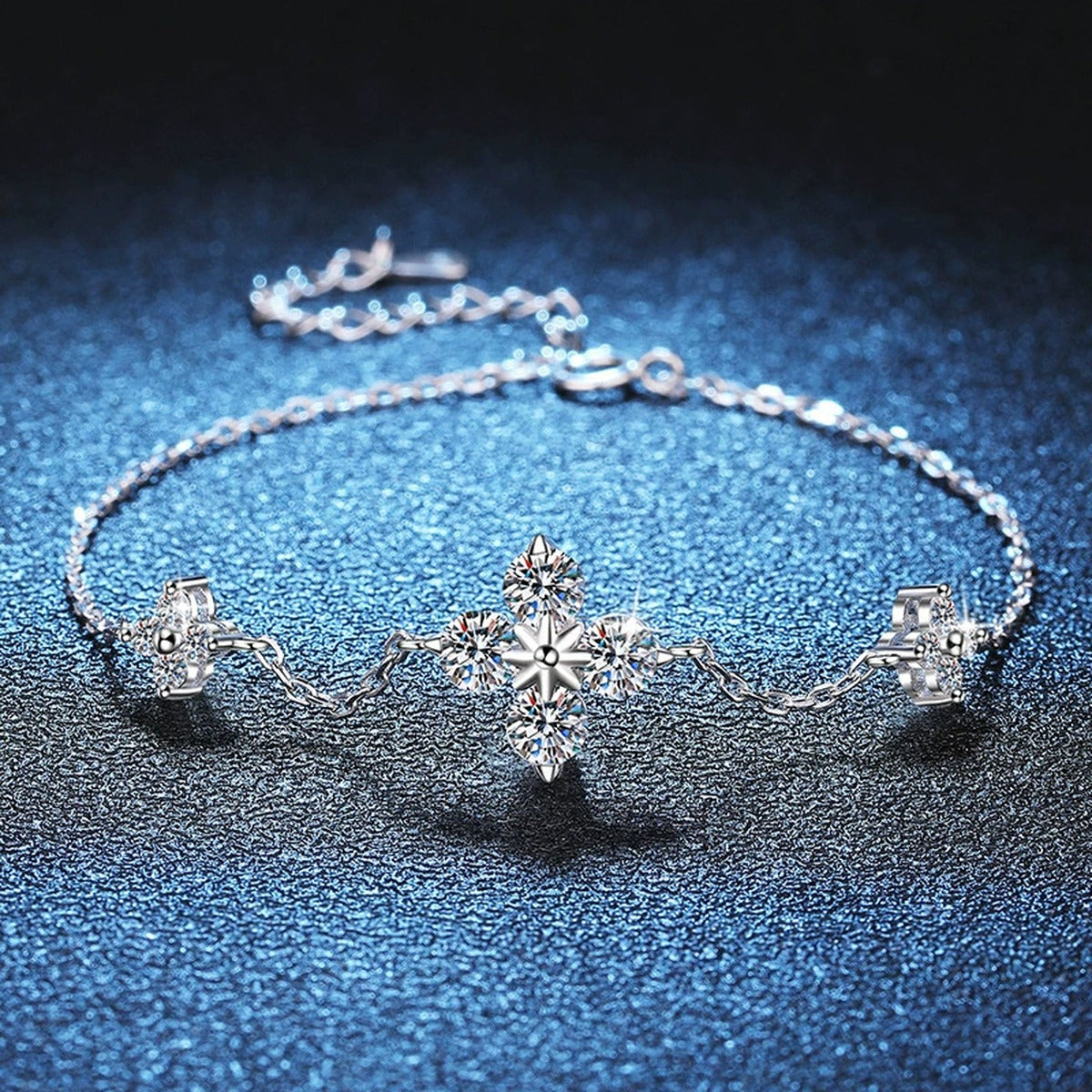 Floral Moissanite Station Bracelet with CZ styled on blue display background with visible moissanite sparkle