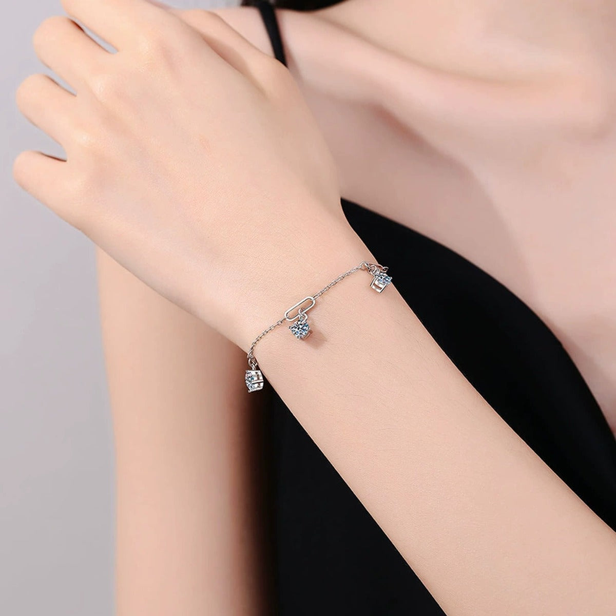 Multi-Charm Moissanite Chain Bracelet worn on wrist by model showing scale and bracelet fit