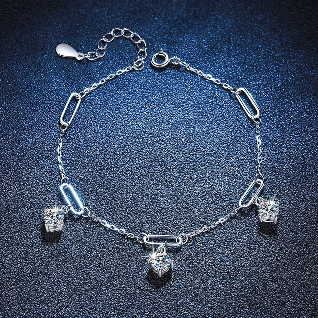 Multi-Charm Moissanite Chain Bracelet styled on blue display background with visible moissanite sparkle