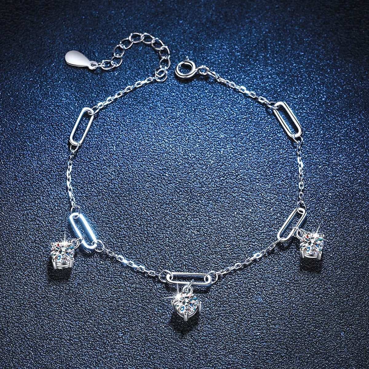 Multi-Charm Moissanite Chain Bracelet styled on blue display background with visible moissanite sparkle