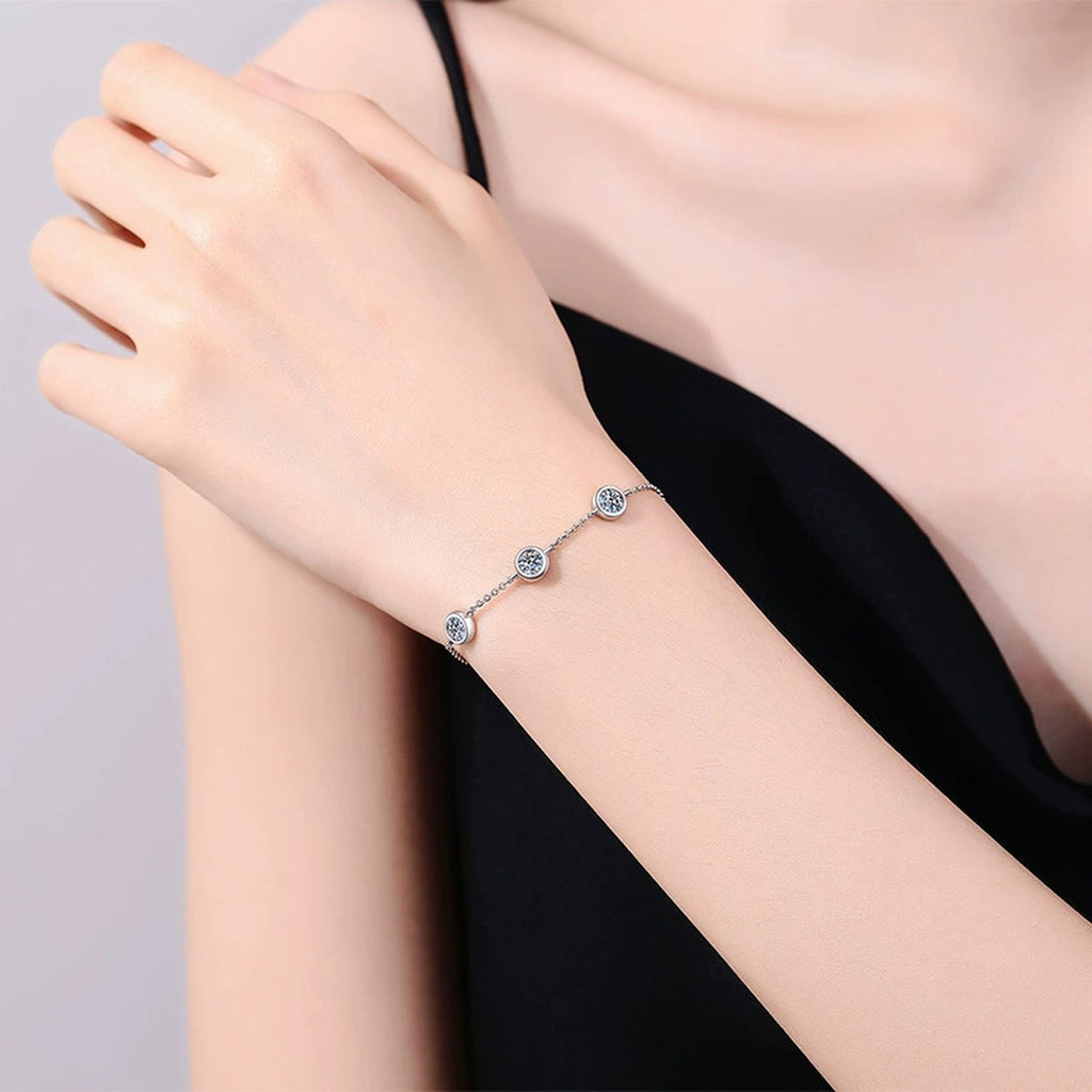 Three-Stone Moissanite Adjustable Station Bracelet worn on wrist by model showing scale and bracelet fit