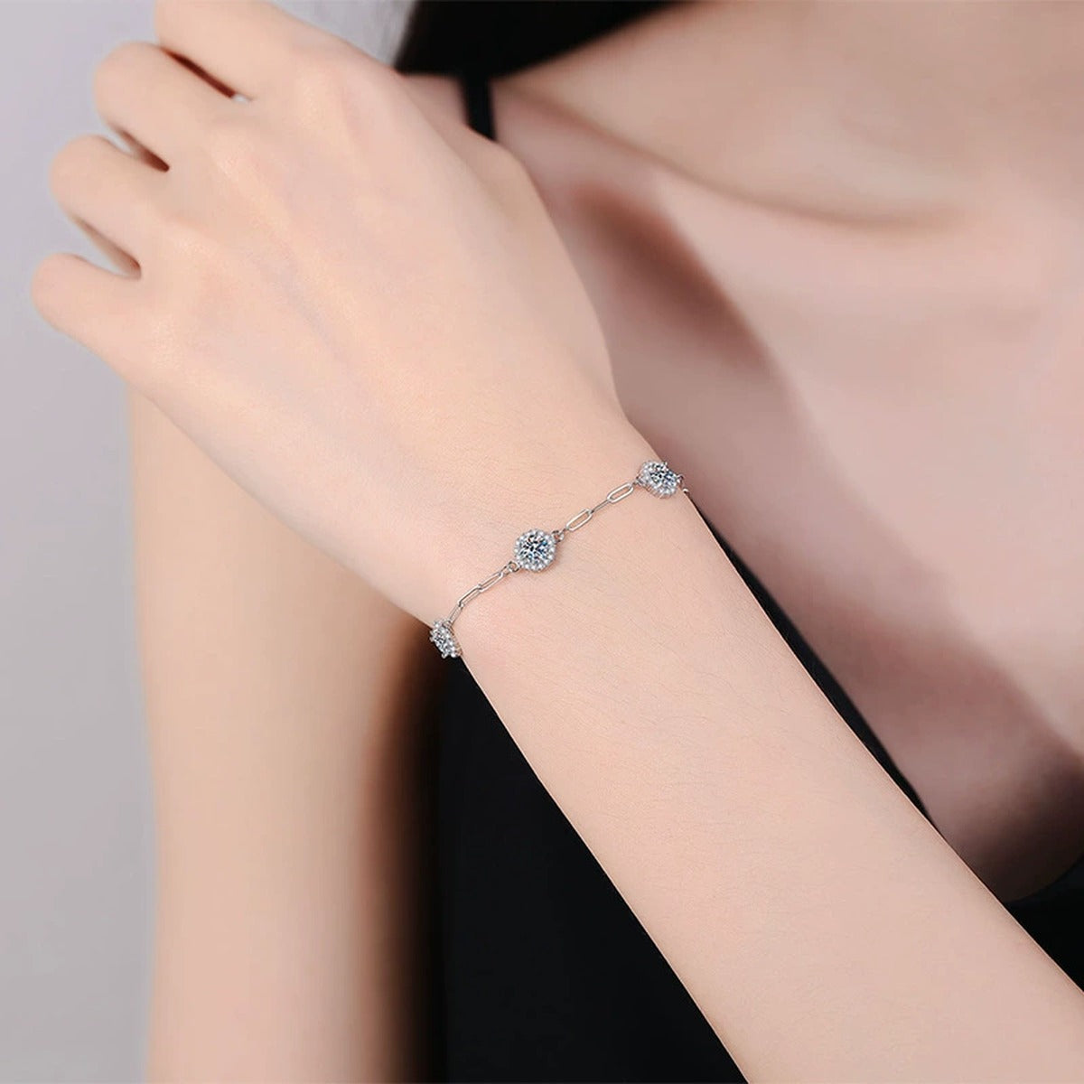 Three-Stone Round Moissanite Chain Bracelet with CZ worn on wrist by model showing bracelet scale and fit