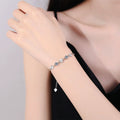 Graduated Moissanite Chain Bracelet with CZ white background product photo showing bracelet silhouette and moissanite setting