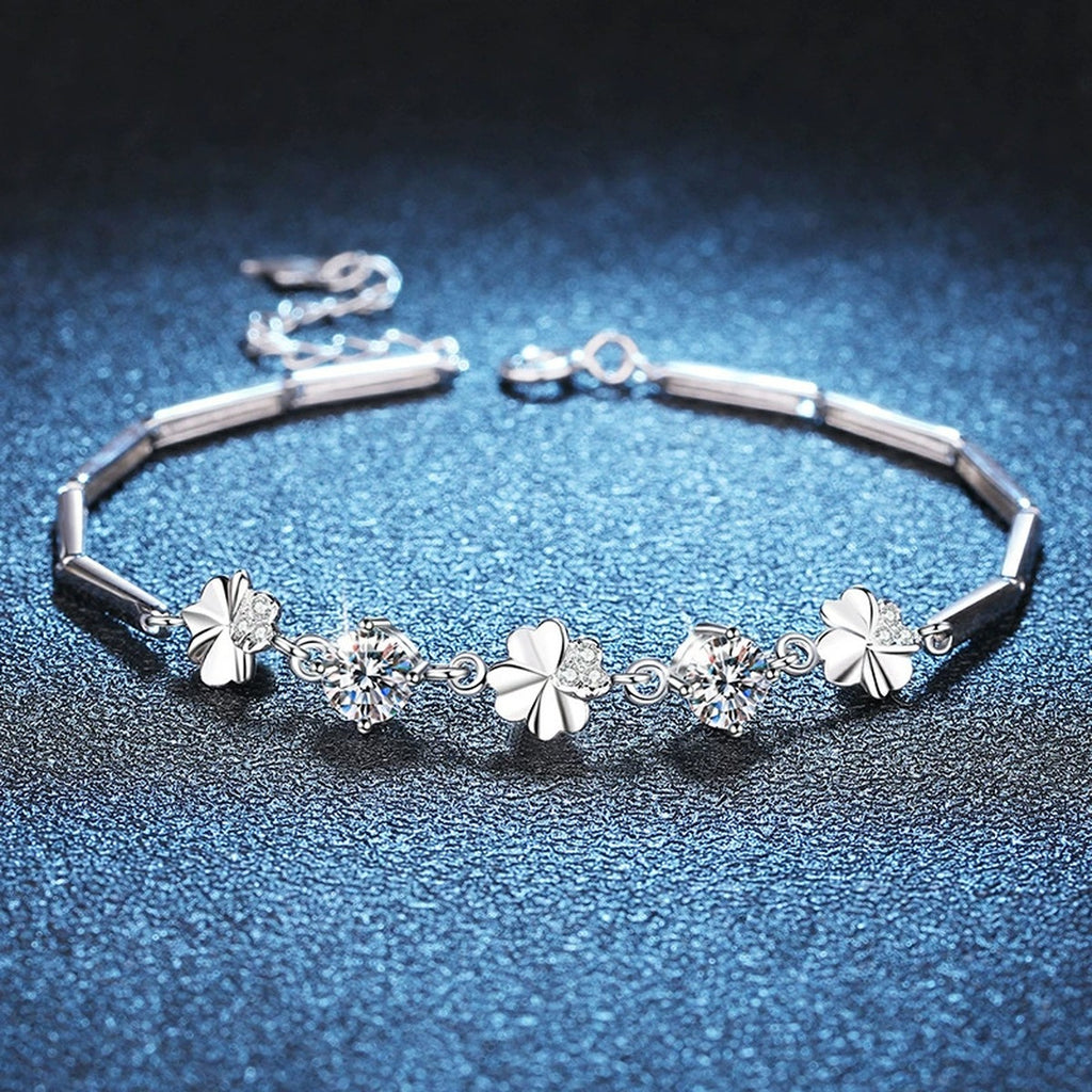 Graduated Moissanite Chain Bracelet with CZ styled on blue display background showing moissanite sparkle