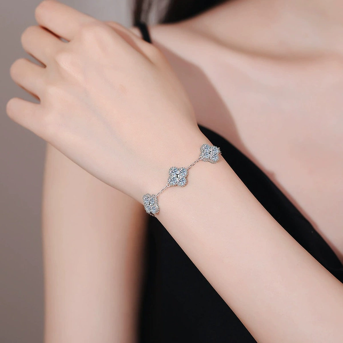 Three-Stone Cushion Moissanite Chain Bracelet worn on wrist by model showing bracelet scale and fit