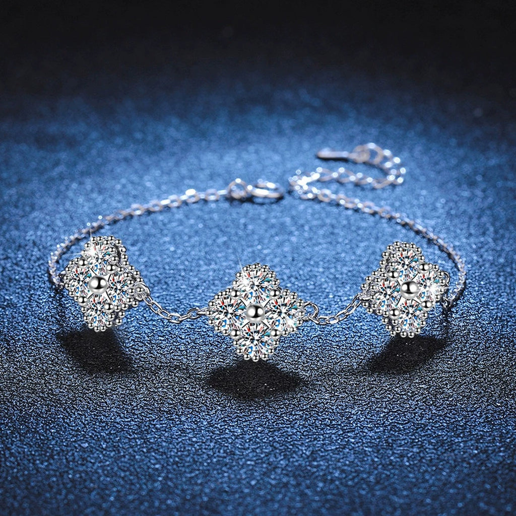 Three-Stone Cushion Moissanite Chain Bracelet styled on blue display background showing moissanite sparkle