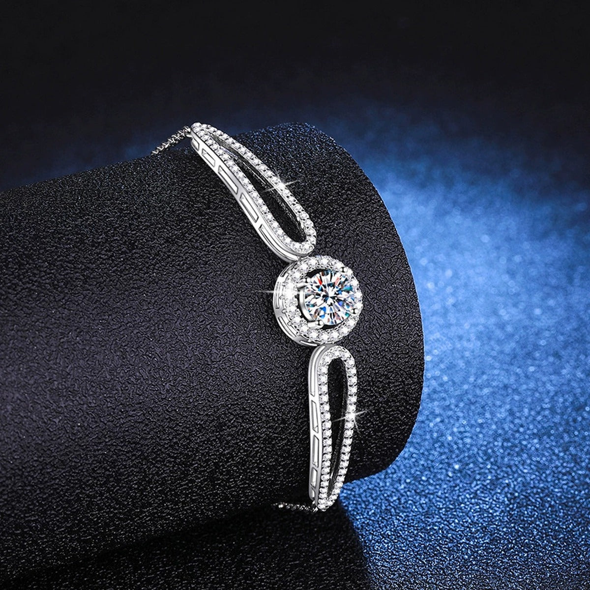 Round Halo Moissanite Adjustable Bangle Bracelet with CZ styled on blue display background showing moissanite sparkle