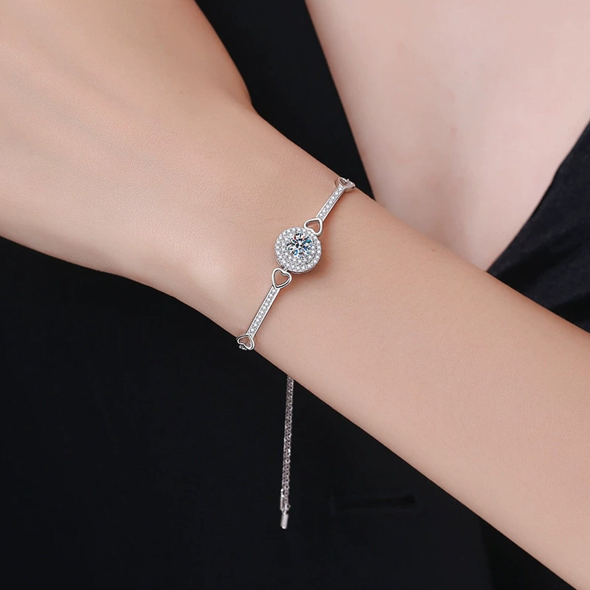 Round Halo Moissanite Adjustable Bangle Bracelet with CZ styled on blue display background showing moissanite sparkle