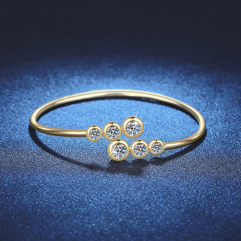 Three-Stone Moissanite Bangle Bracelet white background product photo showing bracelet silhouette and moissanite setting