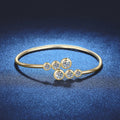 Three-Stone Moissanite Bangle Bracelet white background product photo showing bracelet silhouette and moissanite setting