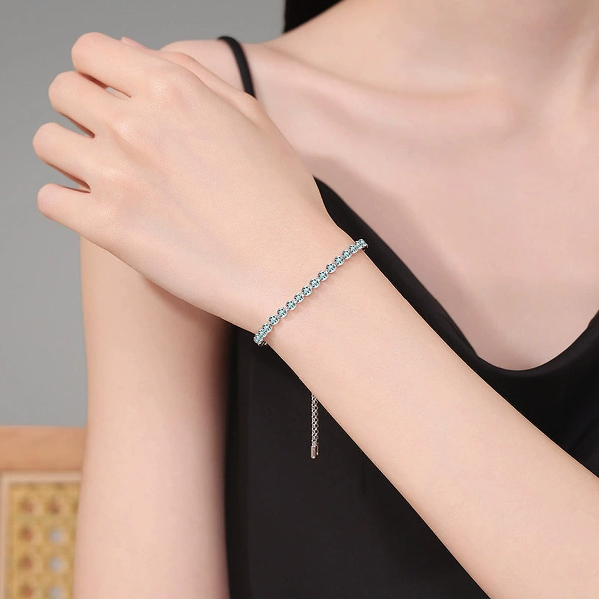 Aqua Moissanite Tennis Bracelet styled on blue display background showing moissanite sparkle