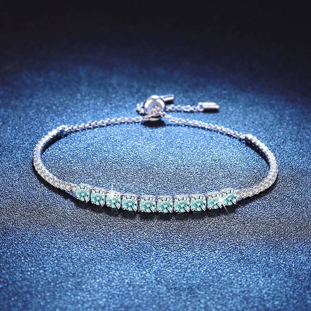 Aqua Moissanite Tennis Bracelet styled on blue display background showing moissanite sparkle