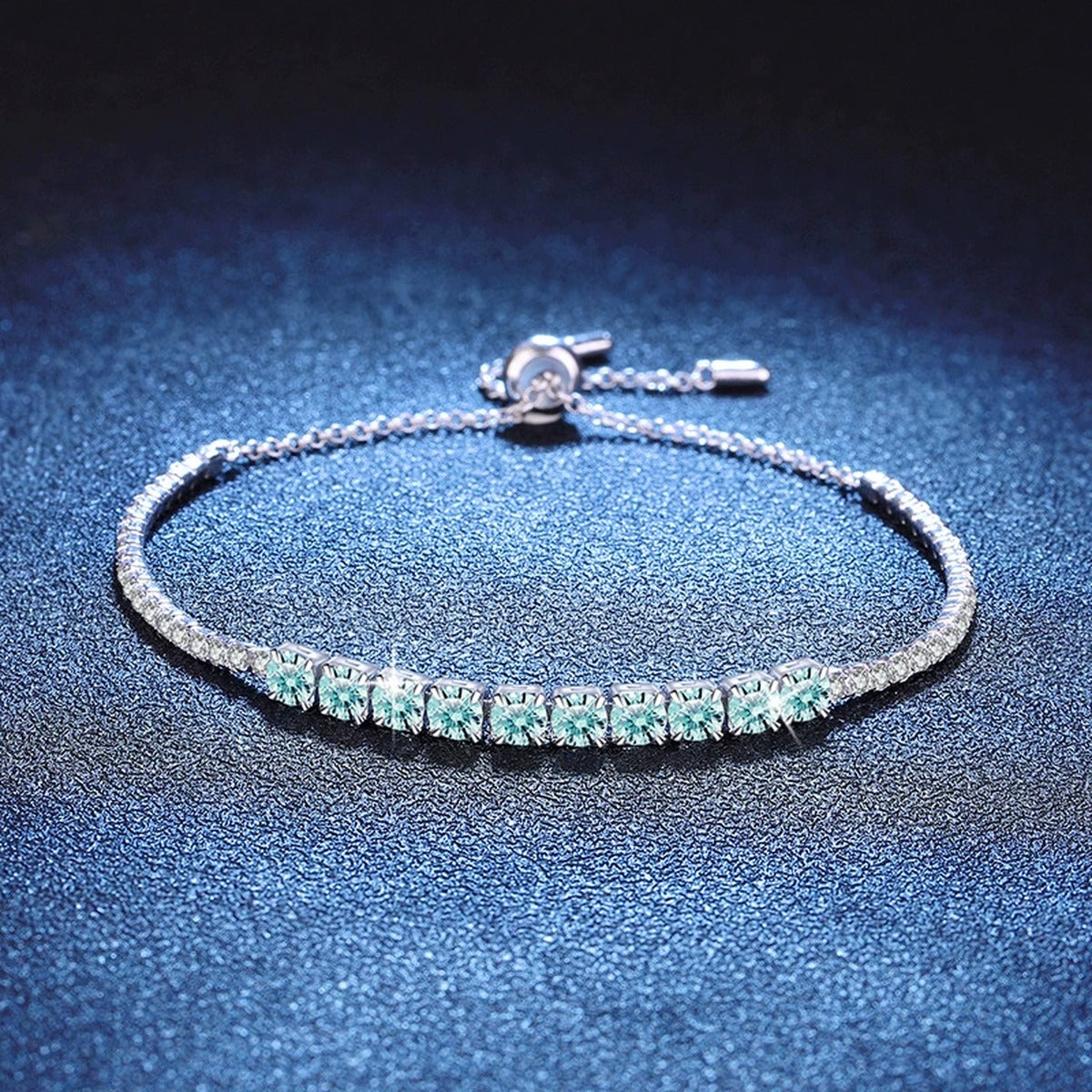 Aqua Moissanite Tennis Bracelet styled on blue display background showing moissanite sparkle