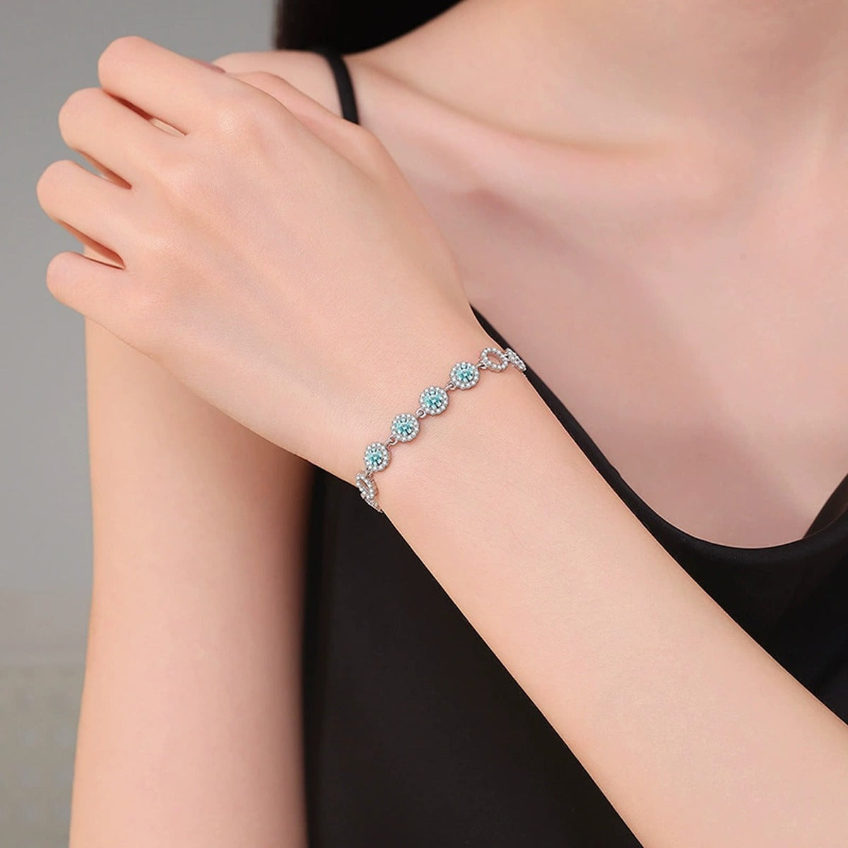 Aqua Moissanite Chain Bracelet with CZ worn on wrist by model showing bracelet scale and fit