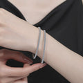 Moissanite Tennis Bangle Bracelet white background product photo showing bracelet silhouette and moissanite setting