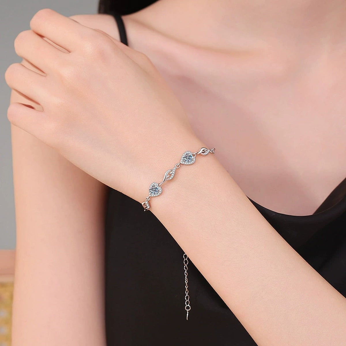 Graduated Moissanite Chain Bracelet with CZ styled on blue display background showing moissanite sparkle