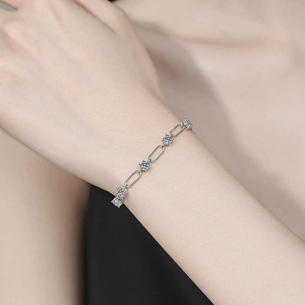 Three-Stone Moissanite Chain Bracelet held in hand close-up showing bracelet scale and detail