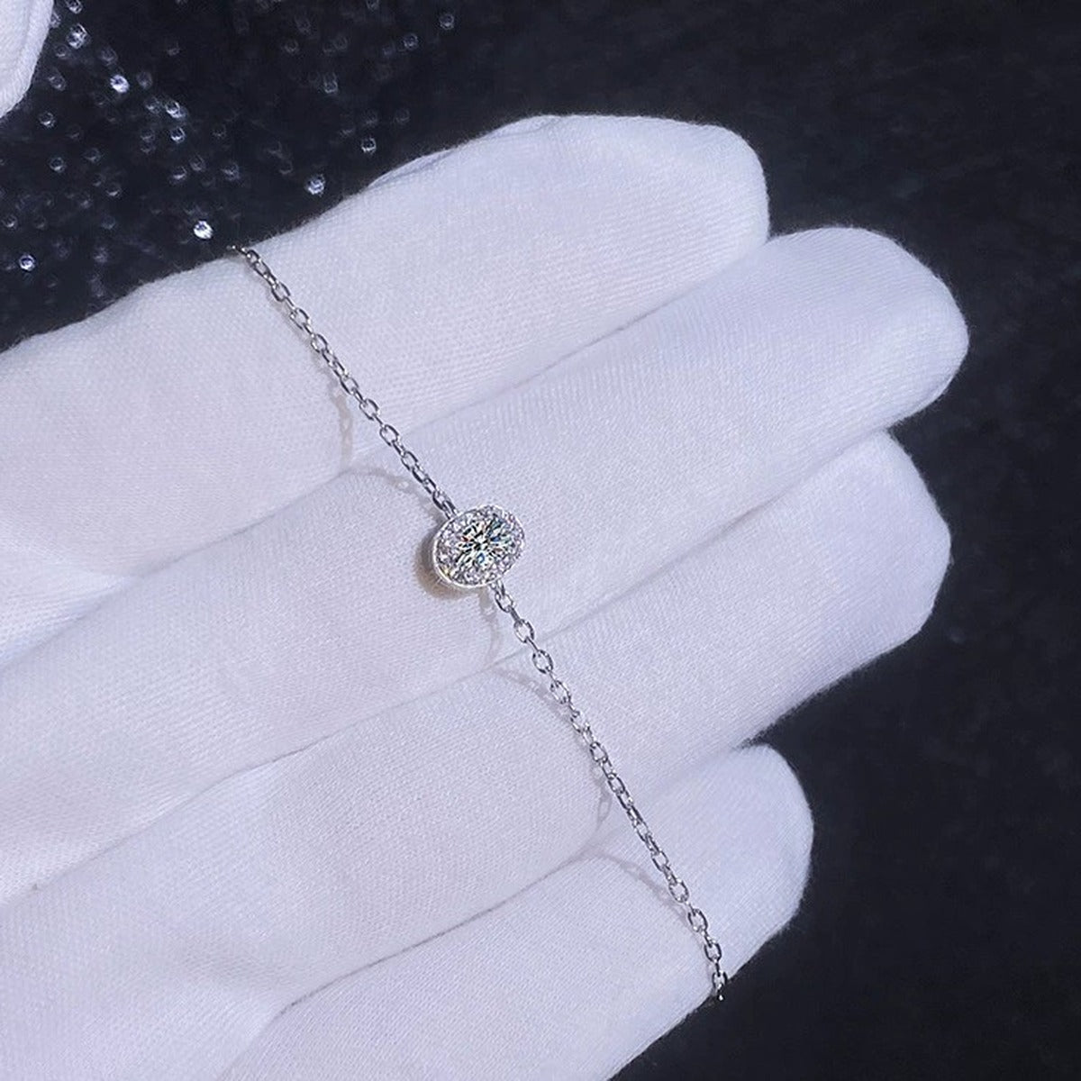 Round Moissanite Chain Bracelet with CZ styled on blue display background showing moissanite sparkle