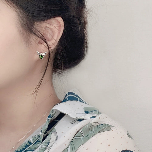 Bee Green Moissanite Stud Earrings with CZ in Gold-Plated S925 sterling silver worn on ear by model showing scale, placement, and stud earrings styling