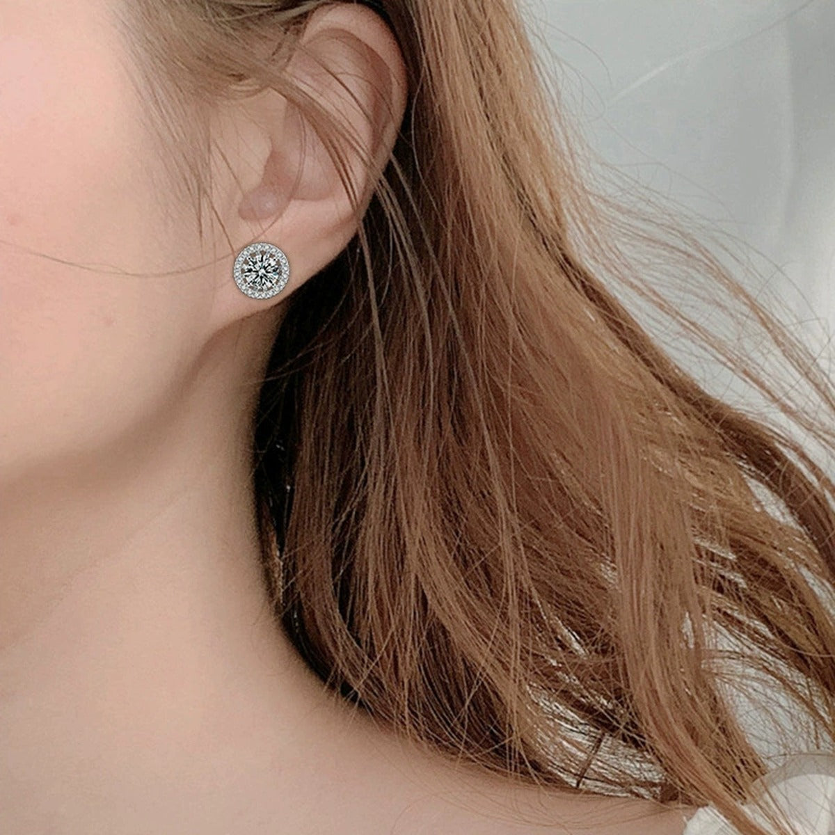 Detachable Halo Round Moissanite Stud Earrings with CZ in White Gold-Plated S925 sterling silver worn on ear by model showing scale, placement, and jacket stud earrings styling