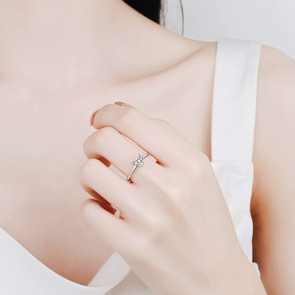 Three-Prong Heart Cut Moissanite Adjustable Engagement Ring worn on hand to show scale, band width, and ring profile