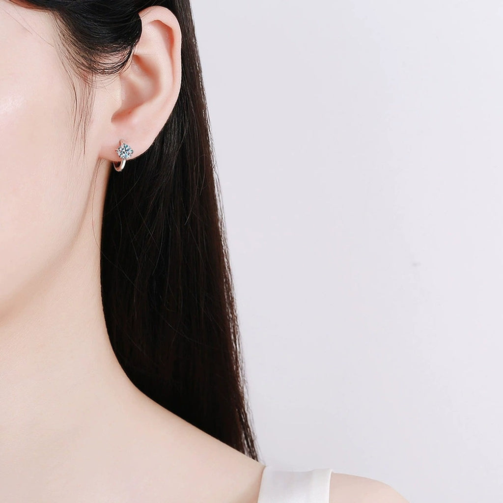 Four-Prong Round Moissanite Huggie Hoop Earrings in Gold-Plated S925 sterling silver worn on ear by model showing scale, placement, and huggie hoop earrings styling