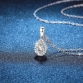 Oval Lab-Grown Gemstone and Moissanite Pendant Necklace in White Gold-Plated S925 Sterling Silver blue background close-up view