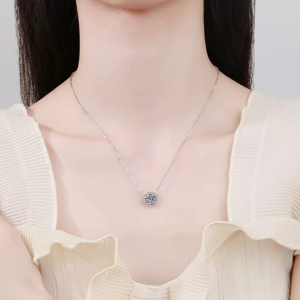 Round Halo Moissanite Pendant Necklace with Cubic Zirconia in White Gold-Plated S925 Sterling Silver worn on neckline by model