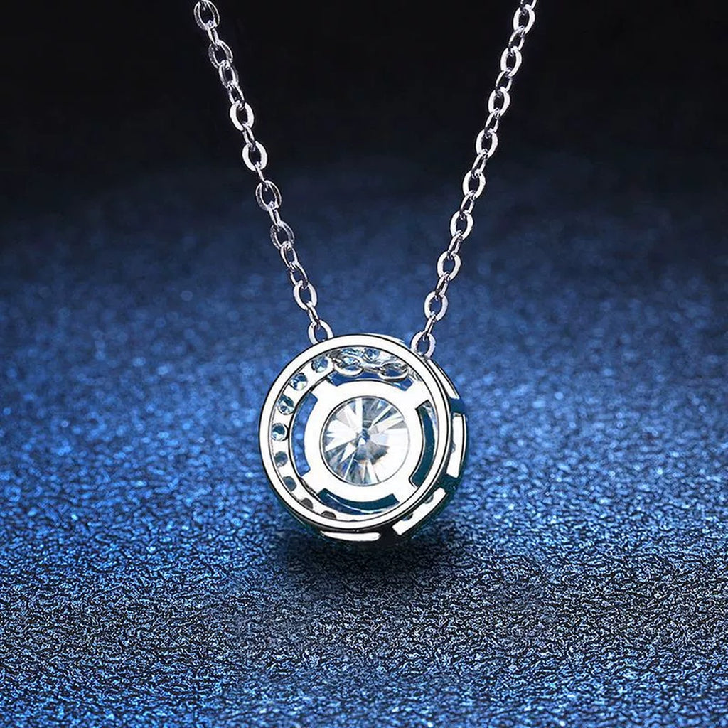 Round Halo Moissanite Pendant Necklace with Cubic Zirconia in White Gold-Plated S925 Sterling Silver blue background angled view