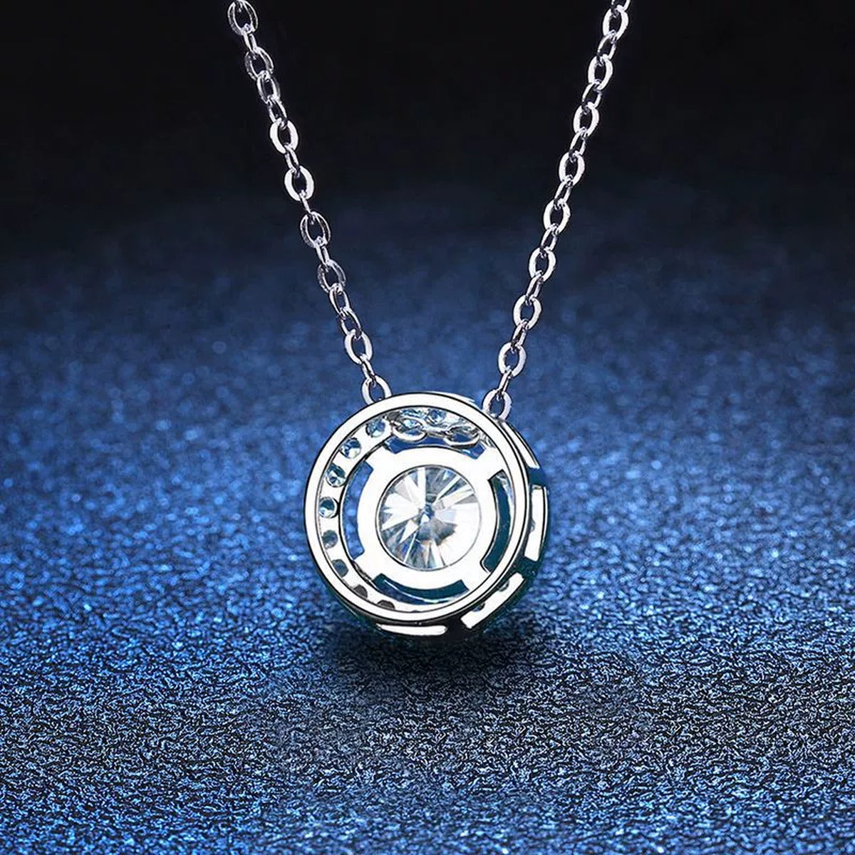 Round Halo Moissanite Pendant Necklace with Cubic Zirconia in White Gold-Plated S925 Sterling Silver blue background angled view