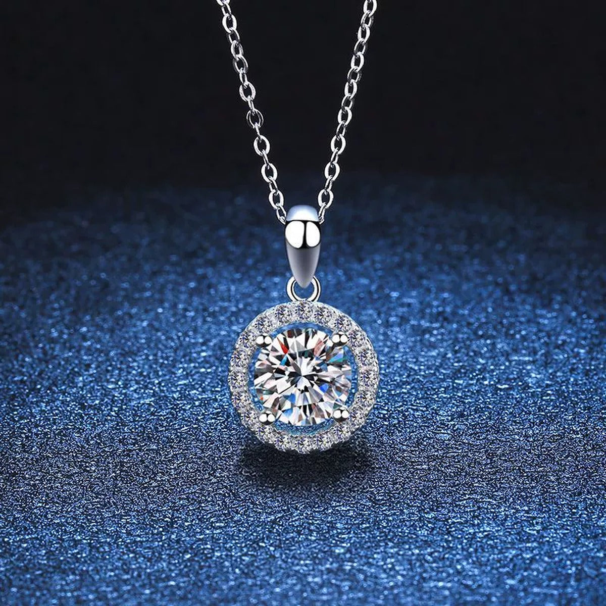 Round Halo Moissanite Pendant Necklace with Cubic Zirconia in White Gold-Plated S925 Sterling Silver blue background close-up view