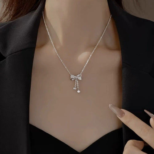 Bowknot Tassel Moissanite Necklace with CZ in White Gold-Plated S925 sterling silver neckline model view showing pendant scale and chain length